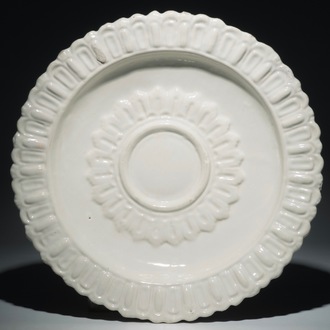 A large monochrome white relief-decorated charger, Marseille, France, 17th C.